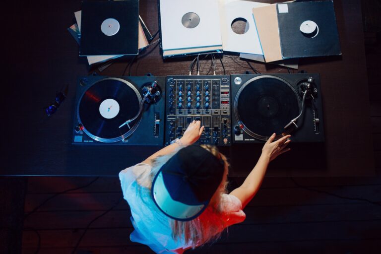 Cute dj woman having fun playing music at club party